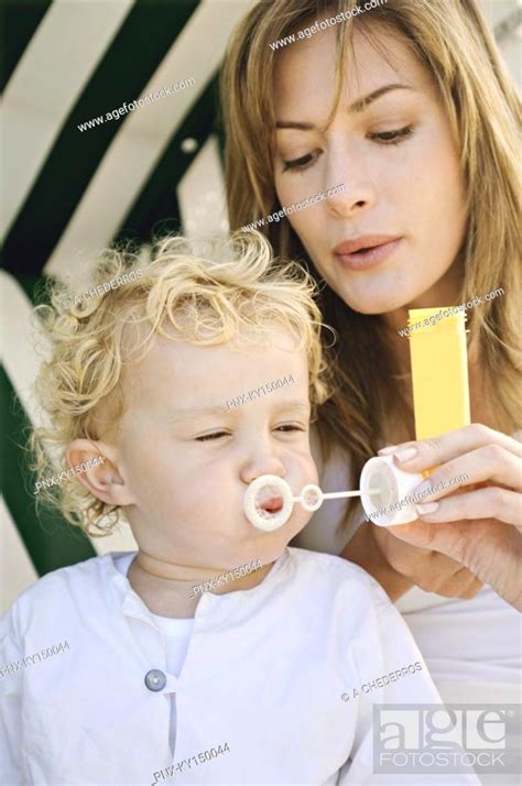 Mother And Son Blowing Soap Bubbles Stock Photo Picture And Royalty