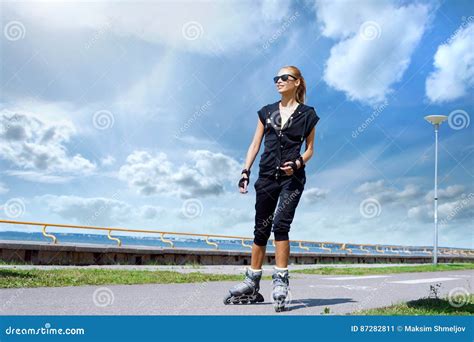 Young Beautiful Sporty And Fit Girl Rollerblading On Inline Sk Stock
