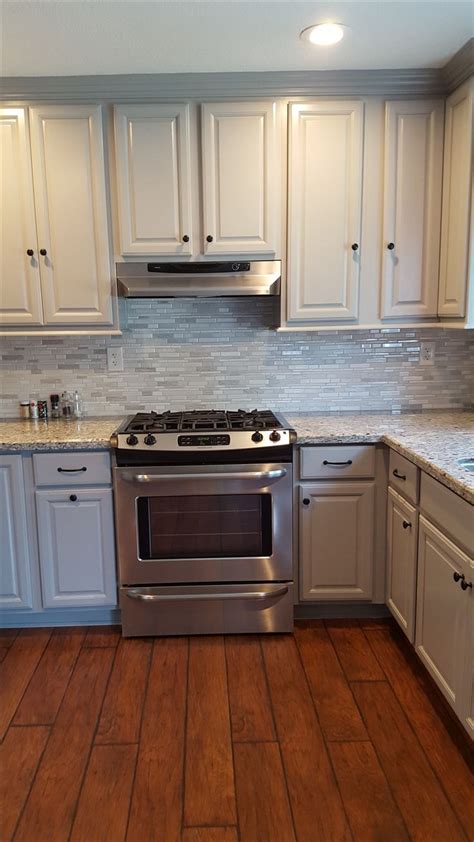 The wide frame is proportioned to the wide reveal that is created by a shallow bevel on the solid wood center panel. After: I decided to go for gray cabinets. I chose pebble grey from KraftMaid. The floor is ...