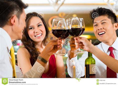 Chinese Couples Toasting With Wine In Restaurant Stock