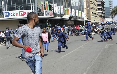 zimbabwe s police beat anti government protesters in capital
