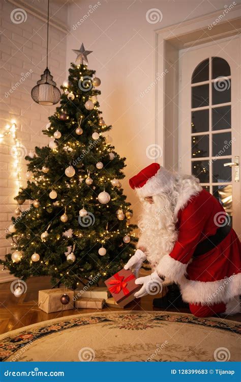 Santa Claus Leaving A Present Under The Christmas Tree Stock Image Image Of List Nicholas