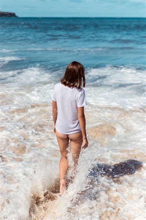 Beautiful Young Woman Posing In Bikini On The Beach Of A Tropical