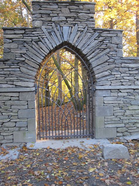 You can own a heavy duty commercial grade simulated stone fence at a fraction of the cost of a traditional masonry wall. Gothic arch in slate with wrought iron gate, built by ...