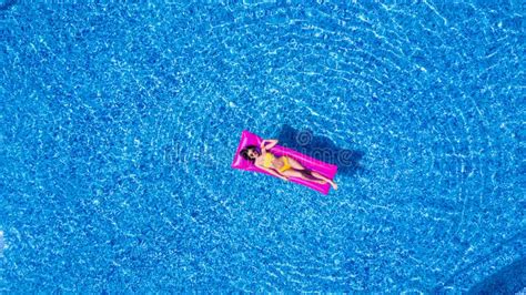 Beauty Woman Rest And Sunbath On A Float In The Pool Top View Aerial