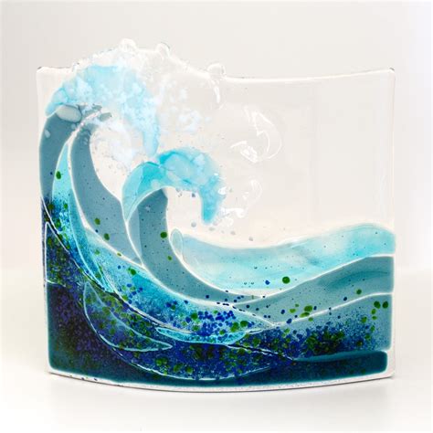 A Curved Piece Of Fused Glass The Depicts Two Waves Crashing Something That Is Often Seen Along