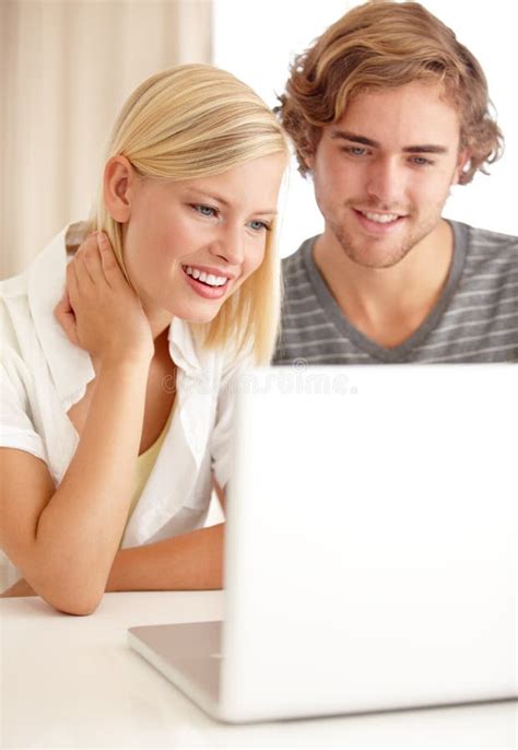 Chatting With Friends Via The Internet A Happy Young Couple Using A