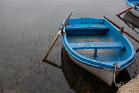 Old Blue Wooden Boat Moored At The Edge Of A Lake Stock Photo Image