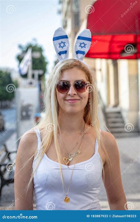 Beautiful Woman With Glasses On The Street Of Tel Aviv With The Flags