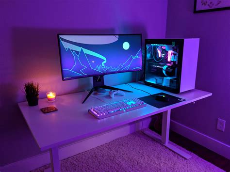 Two Computer Monitors Sitting On Top Of A White Desk In Front Of A