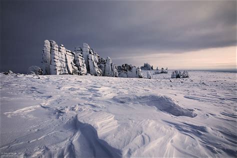 Snow Covered Stone Pillars Of Ulakhan Sis · Russia Travel Blog