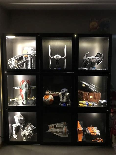A Display Case Filled With Legos And Star Wars Vehicles In Its Glass Cases
