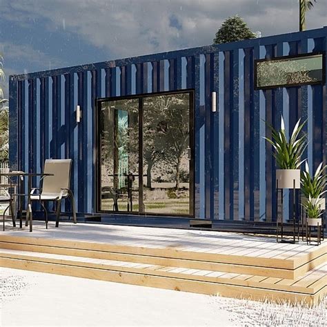 A Blue Shipping Container Sitting On Top Of A Wooden Deck Next To A