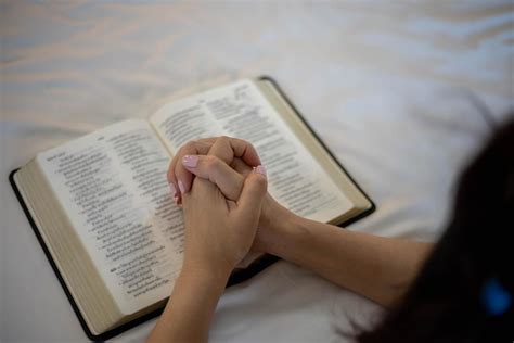Woman Hand Praying On Holy Bible In The Morning Study Bible With