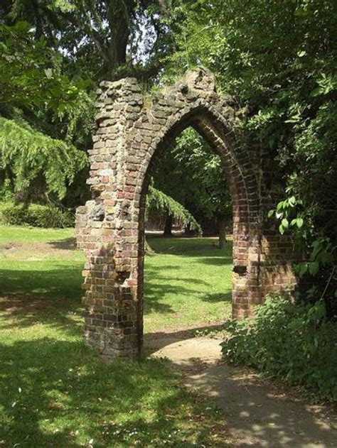 A Stone Garden Arch Resembling Part Of An Old Ruin Makes An Interesting
