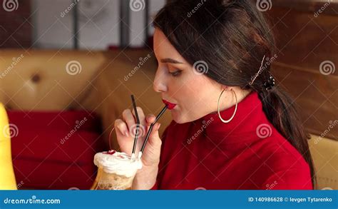 Girl With Red Lipstick Is Drinking A Cocktail From A Straw While Sitting In Cafe Stock Footage