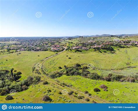 Aerial View Of Green Valley With Big Luxury Villa On The Background In