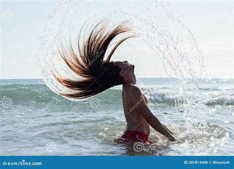 Closeup Shot Of A Young Man With Long Hair Doing A Hair Flip In The