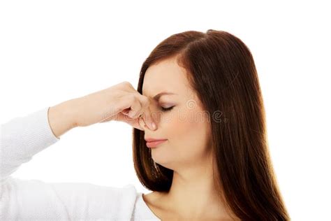 Young Woman Holding Her Nose Because Of A Bad Smell Stock Photo Image
