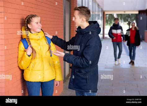 Two Teenage Students Talking Near College Stock Photo Alamy