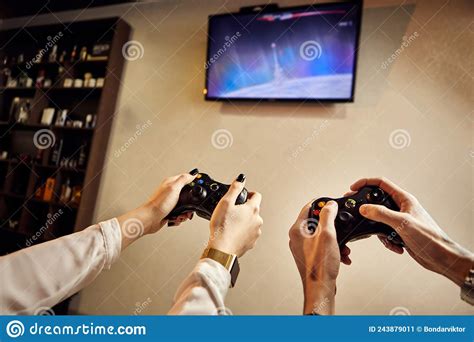 Playful Couple Gamers Enjoying Playing Video Games Indoors Sitting On