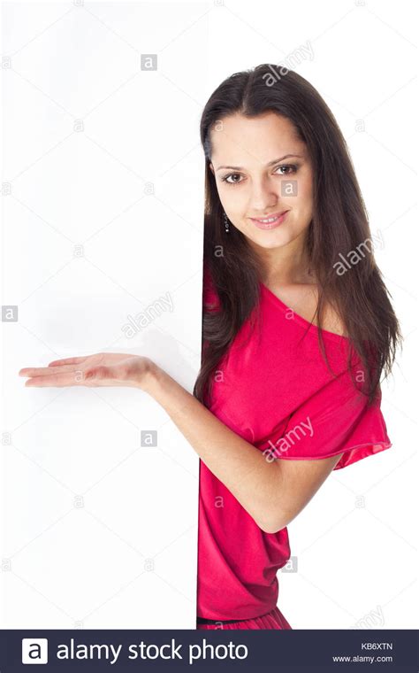 Pretty Young Smiling Woman In Red Dress Showing Blank Signboard