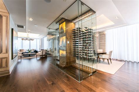 Glass Enclosed Wine Cellar With A Stone Wall By Papro Consulting Featuring The Cable Wine System
