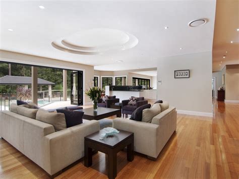 Open Plan Living Room Using White Colours With Hardwood And Exposed Eaves