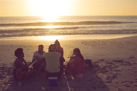 Group Of Friends Having Fun At Beach During Sunset Stock Image Image