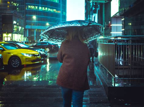 Woman Walking In Street With Umbrella During Nighttime · Free Stock Photo