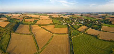 Aerial Panorama Over Rural Patchwork Quilt Of Farms Crops Fields Stock
