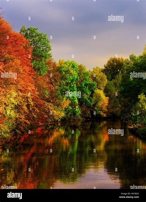 Colorful Autumn Outdoor Image At A Riverside With Red Yellow Green