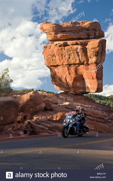 A carnet de passage will not work. Couple on a motorcycle ride past Balanced Rock, Garden of ...