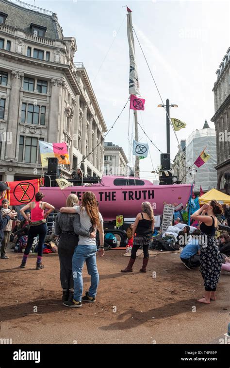 Extinction Rebellion Protesters Embrace And Dance As They Occupy Oxford Circus Behind Is A