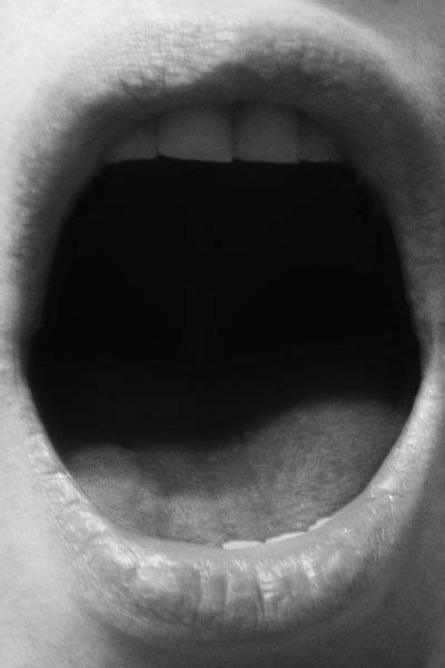 An Open Mouth Is Shown In Black And White