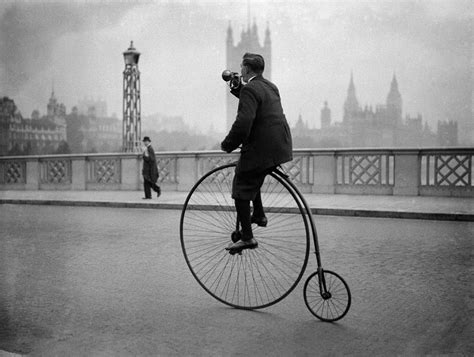 man rides a penny farthing bicycle over by fox photos