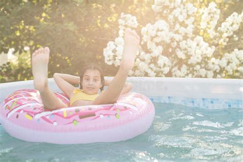 Girl Plays An Inflatable Ring Is In Swimming Pool In The Garden Stock Image Image Of Blue