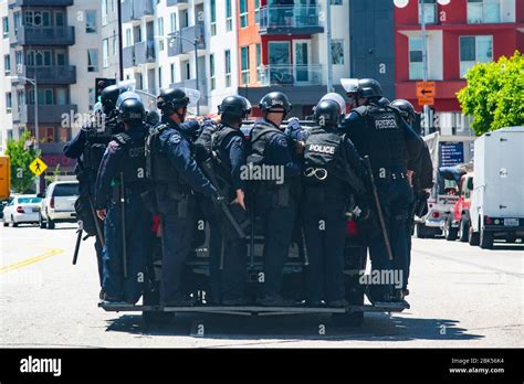 police swat team preparing for civil unrest ride in police vehicle during a black lives matter