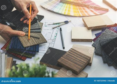 Designer Choosing Flooring And Furniture Materials From Samples For