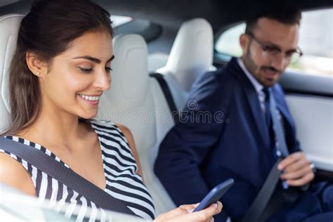 Couple Of Businessmen Sitting On The Back Seat In Car Stock Photo