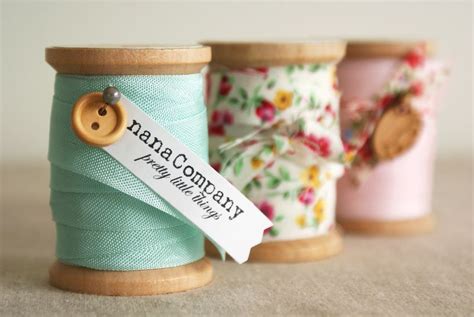 Wood Spools Wrapped With Ribbon Pinned With Button And Names Escort