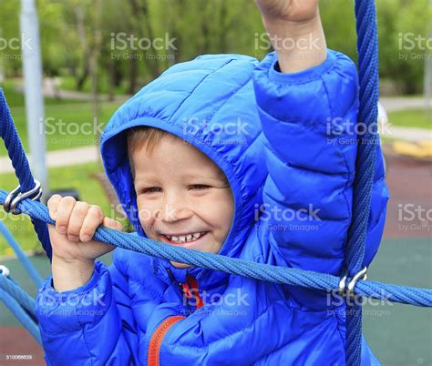 Child Climbing Rope On The Playground Stock Photo Download Image Now