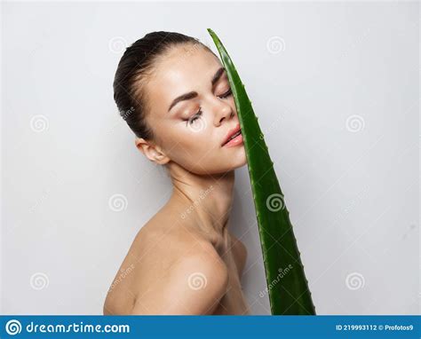 Woman With Green Aloe Leaf On Light Background Cropped View Naked