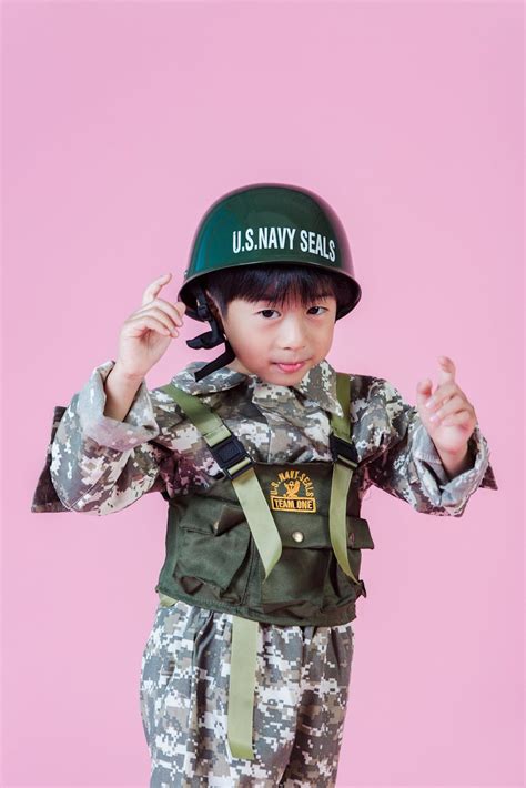 Little Asian kid in navy uniform in studio · Free Stock Photo