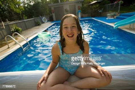 Girl Sitting On Edge Of Swimming Pool Photo Getty Images