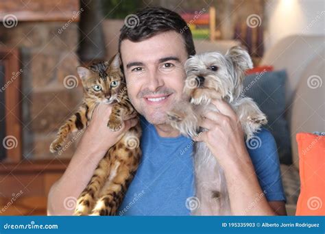 Man Holding Cat And Dog Stock Image Image Of Cuddle 195335903