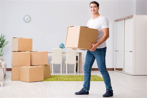 Premium Photo Young Man Moving Boxes At Home