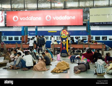 People Waiting For A Train At Delhi Railway Station In India Stock