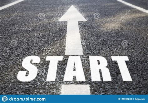 Close Up Of Arrow And Word Start On Asphalt Road Stock Photo Image Of