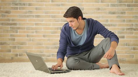 Handsome Guy Sitting On Floor And Using Laptop Stock Video Footage